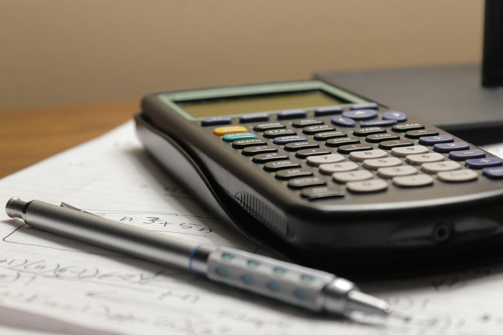 Calculator and pen on top of paperwork