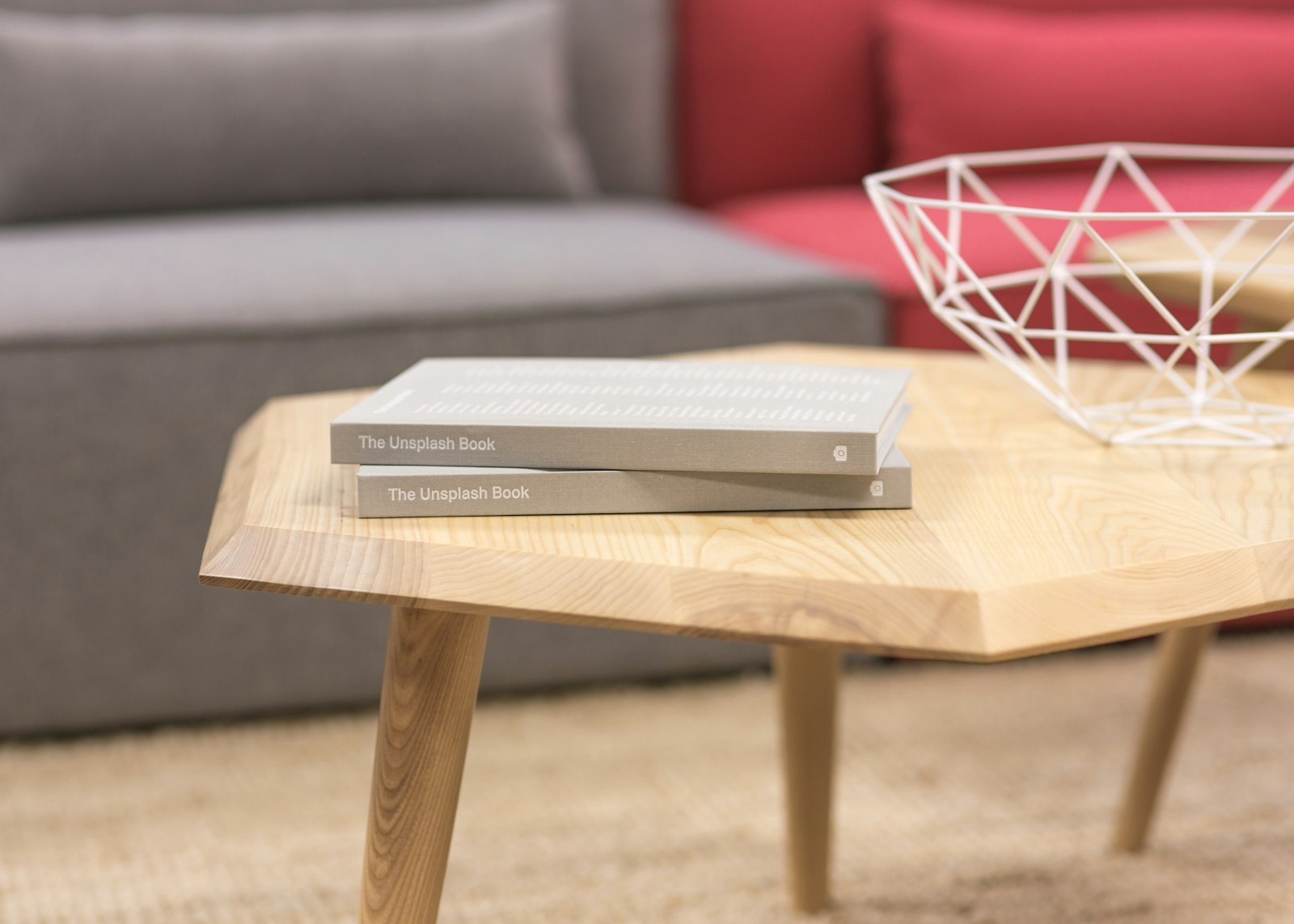 Books resting on a wooden coffee table in a living room